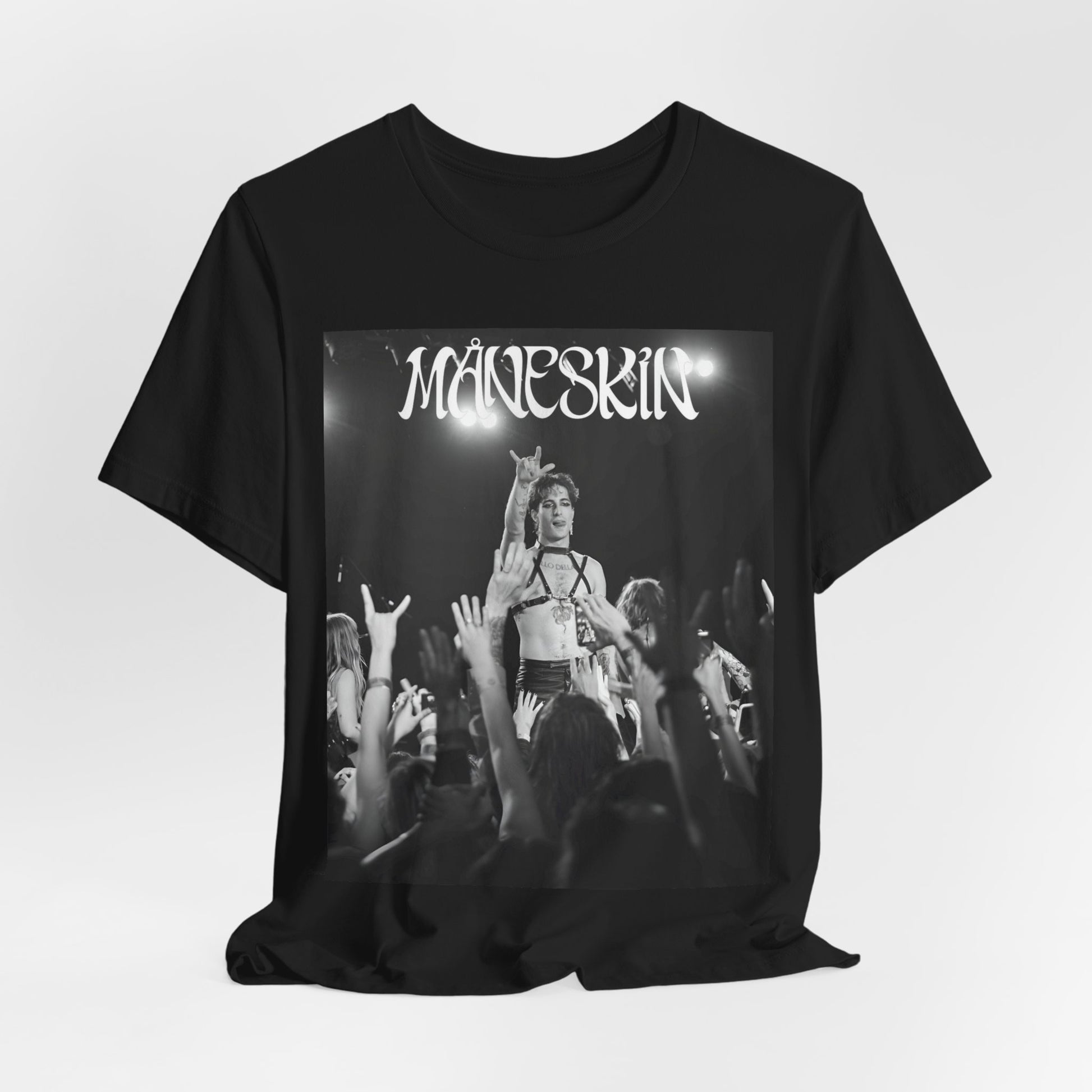 A black graphic t-shirt featuring a graphic or photo of Maneskin performing live.