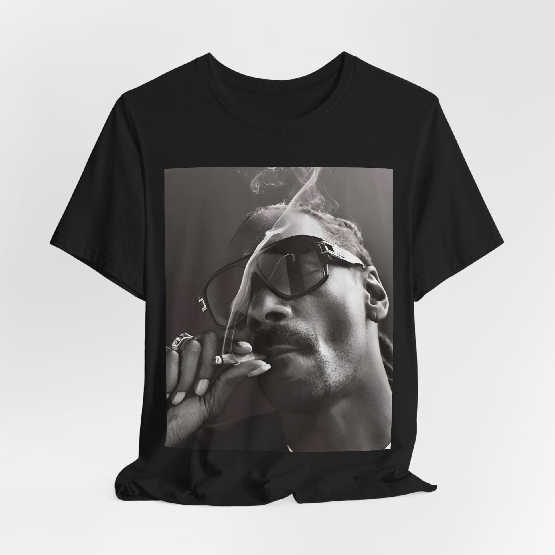 A black graphic t-shirt featuring an iconic black and white shaded portrait graphic of Snoop Dogg.