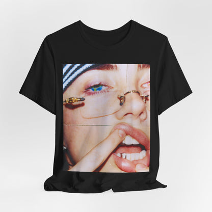 A direct, unfiltered, close-up portrait of Billie Eilish with dark hair looking straight at the camera, printed on a t-shirt.