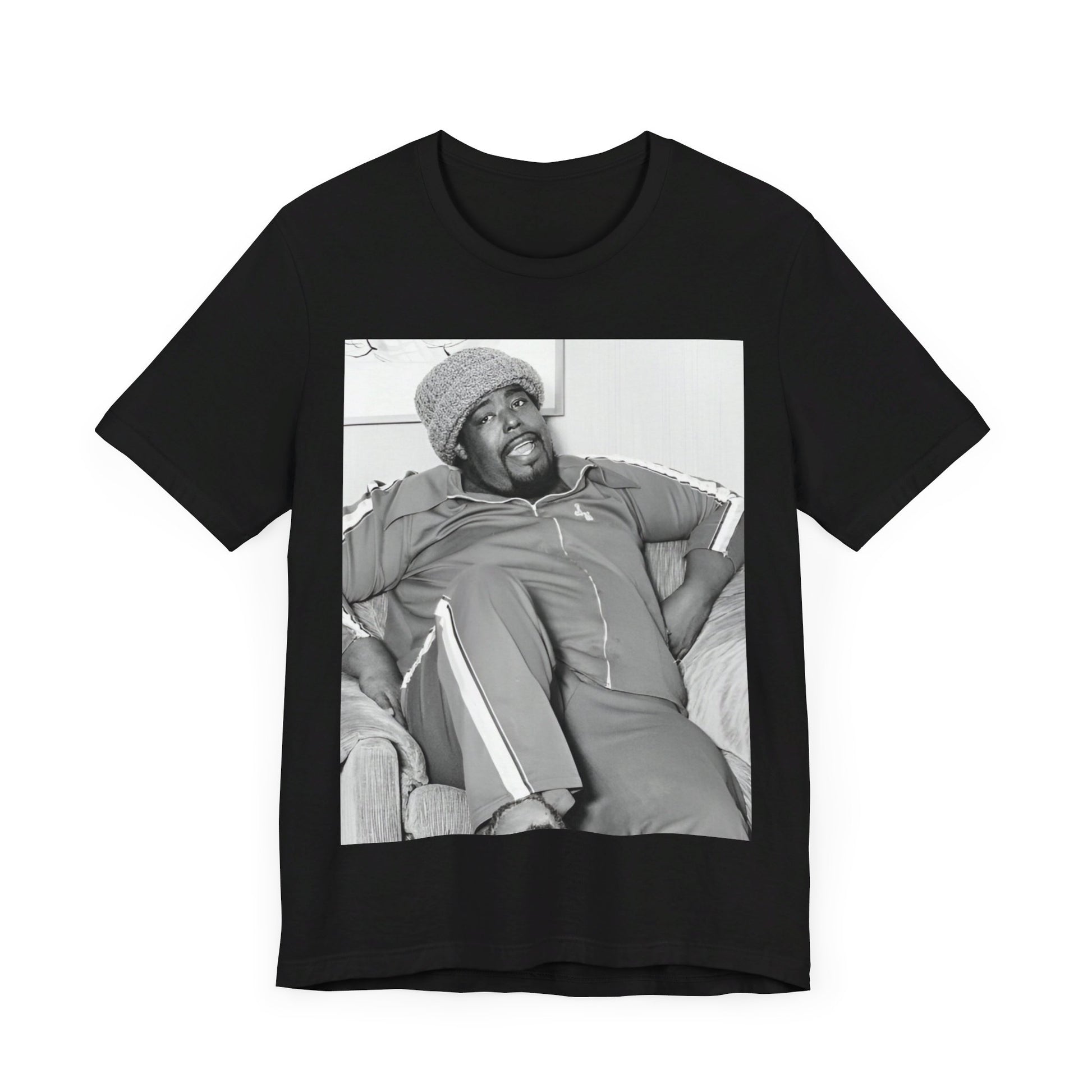 A black graphic t-shirt featuring a 70s-style portrait photo of Barry White in a lounge setting.