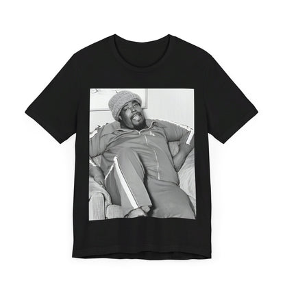 A black graphic t-shirt featuring a 70s-style portrait photo of Barry White in a lounge setting.