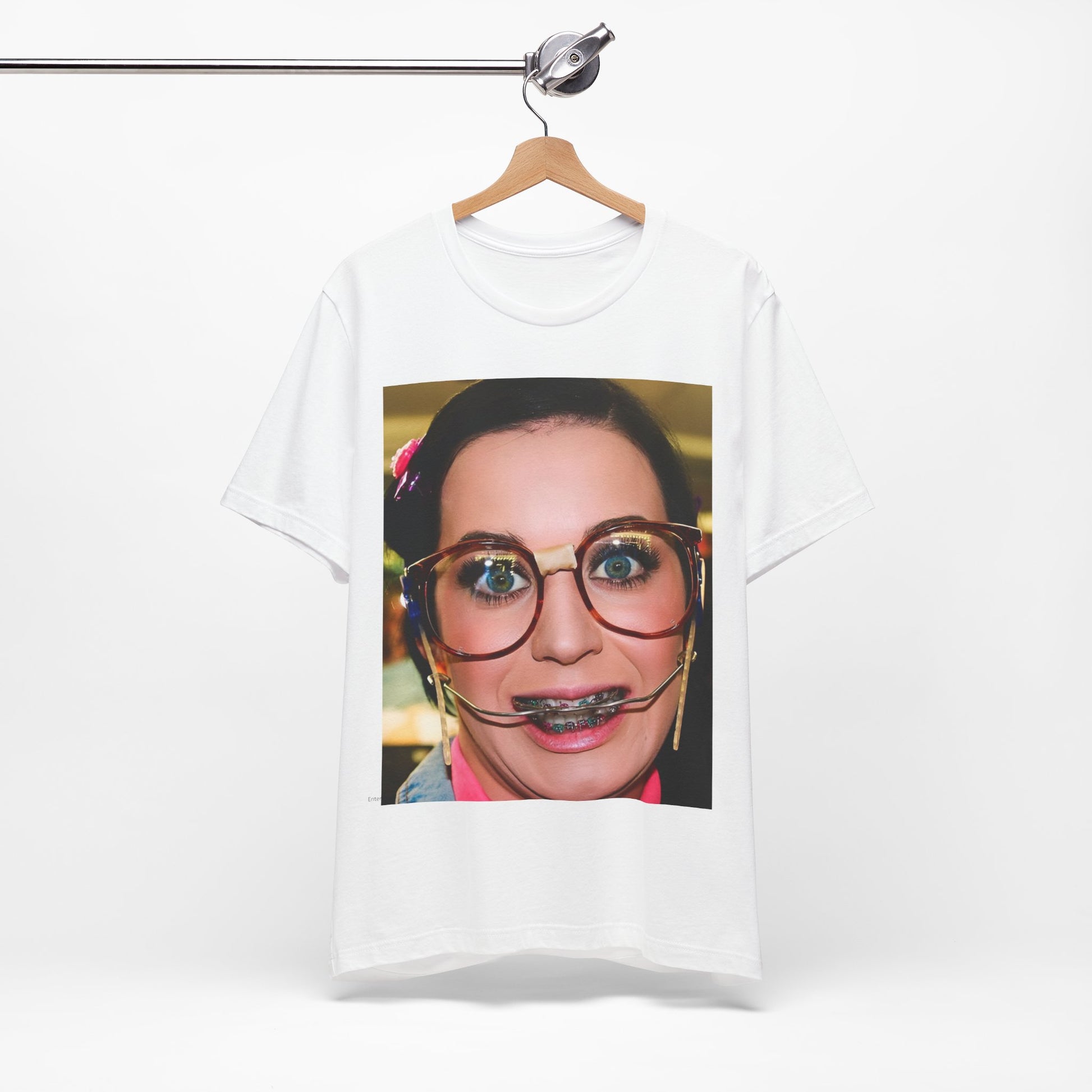 A black graphic t-shirt featuring a graphic related to Katy Perry's "I Kissed A Girl" song or era.