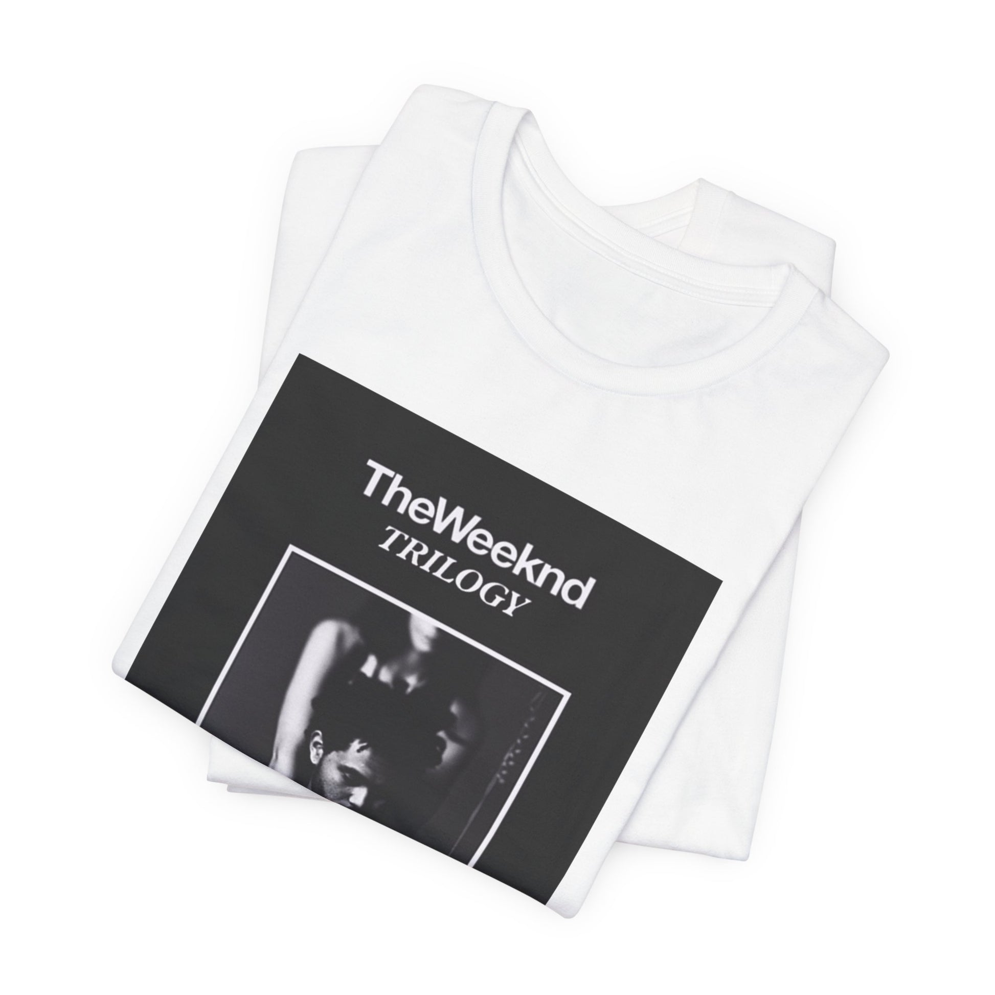 A black graphic t-shirt featuring a graphic related to The Weeknd's 'Trilogy' album.
