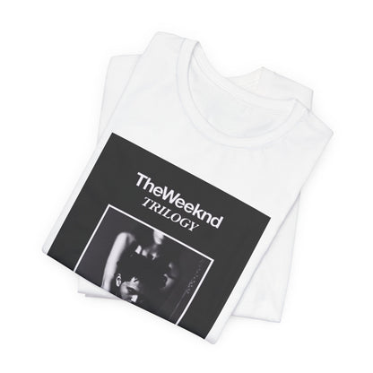 A black graphic t-shirt featuring a graphic related to The Weeknd's 'Trilogy' album.