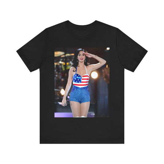 A black graphic t-shirt featuring a vintage graphic related to Katy Perry's 'Firework' song or era.