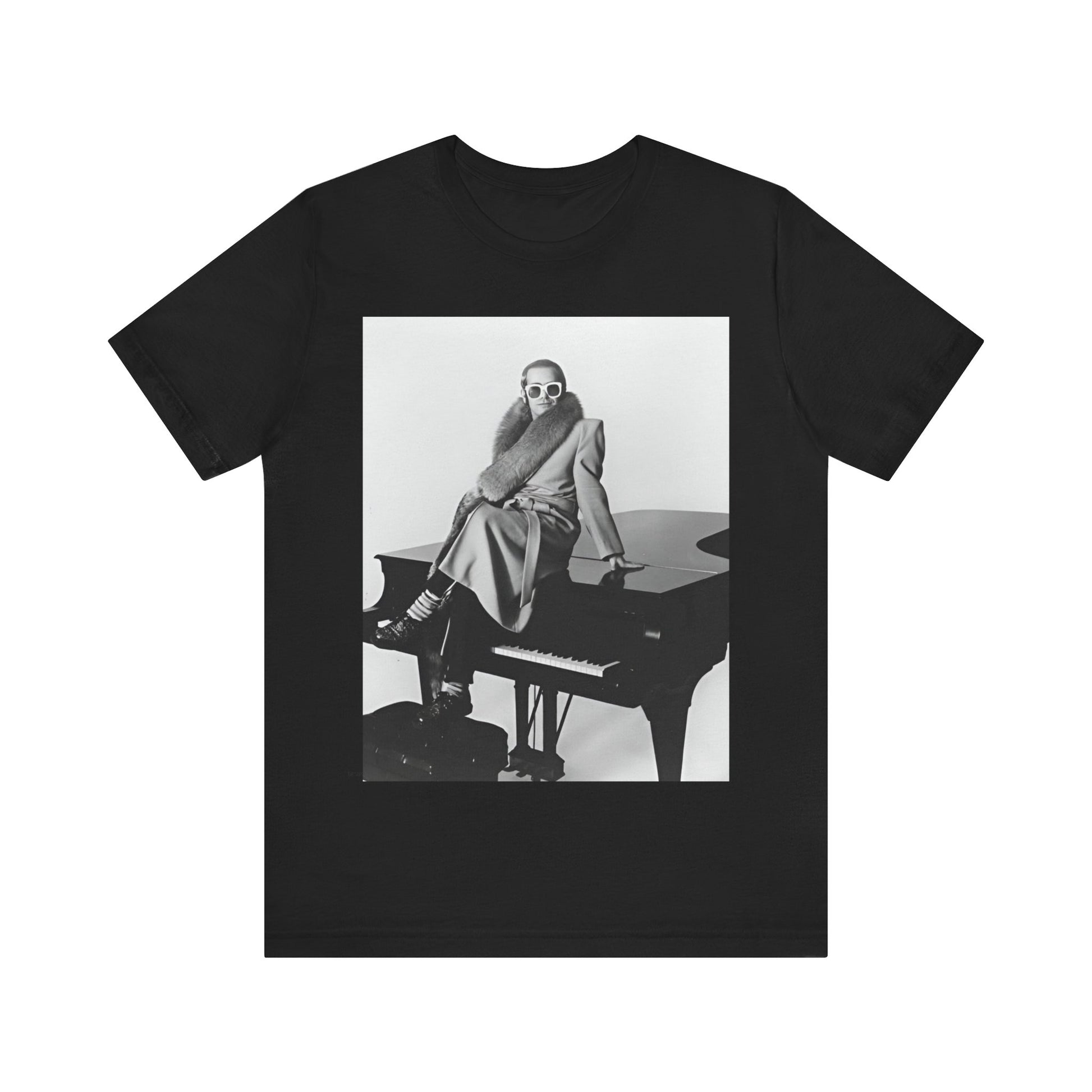 A black graphic t-shirt featuring a black and white photo of Elton John playing the piano.