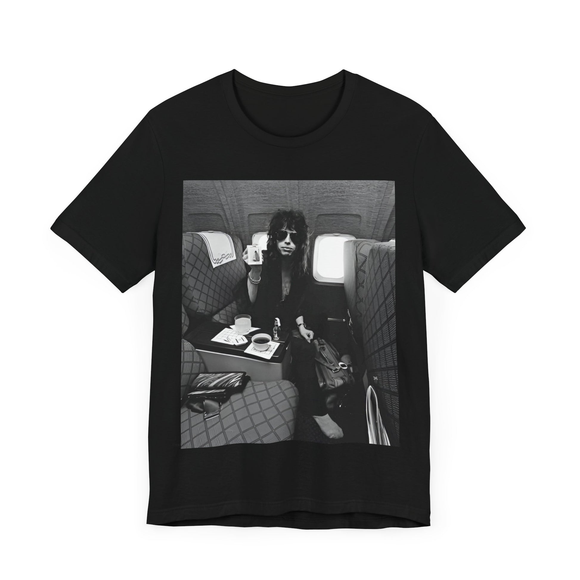 A black graphic t-shirt featuring a vintage 70s-style illustration of an airplane with Aerosmith branding, representing their tour plane from that era.