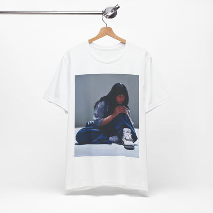 An artistic and slightly melancholic graphic t-shirt inspired by Billie Eilish's song "Lovely," featuring soft colors and a dreamy style.