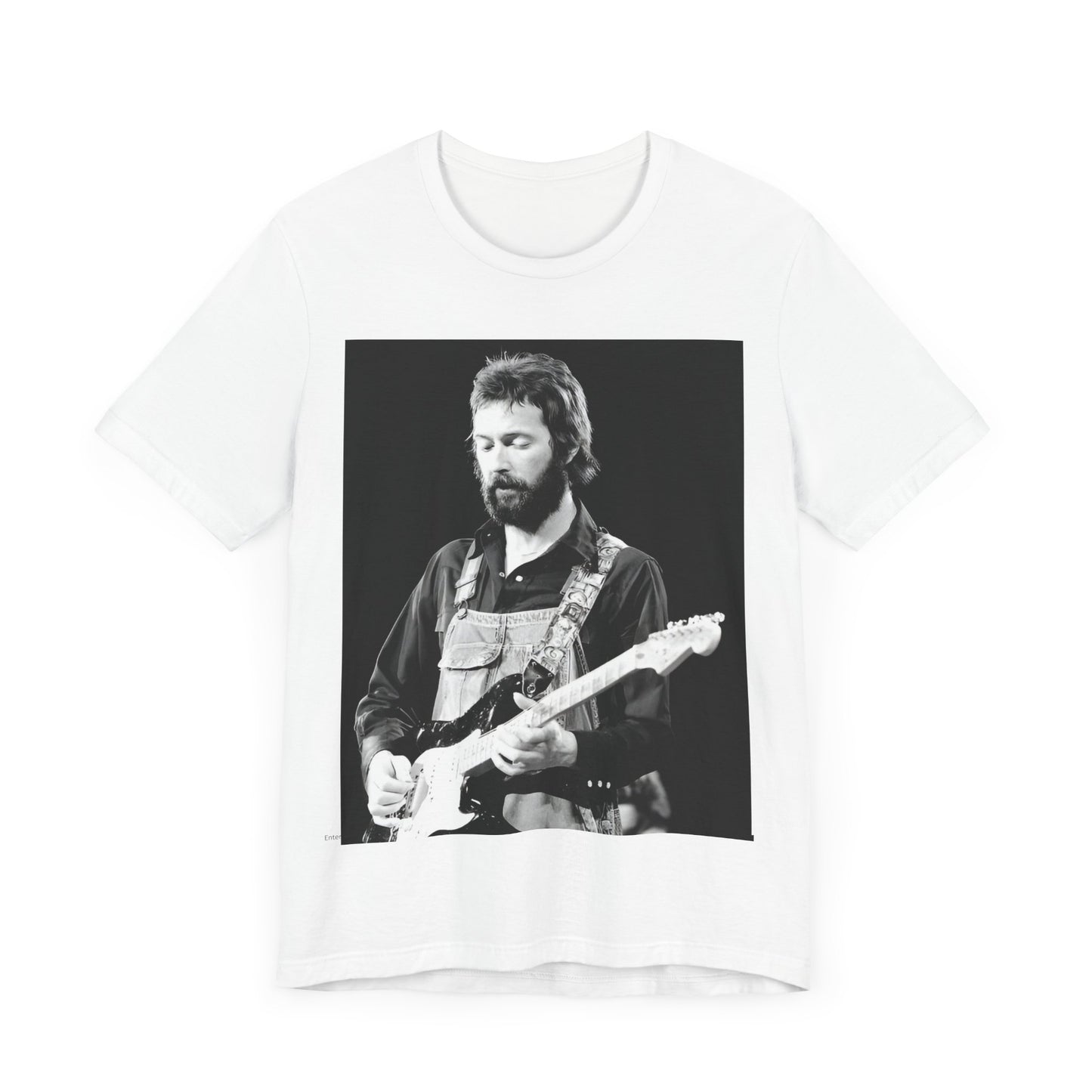 A black graphic t-shirt featuring a graphic or photo of Eric Clapton performing live on stage with his guitar.