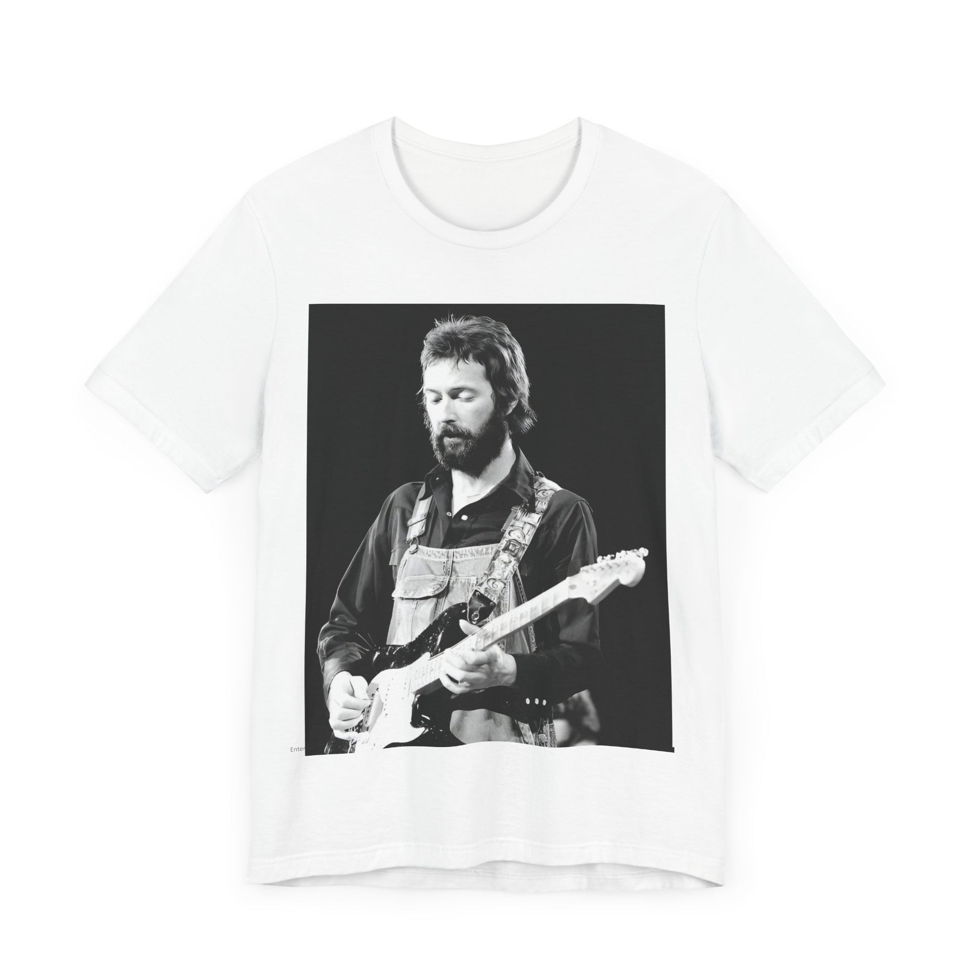 A black graphic t-shirt featuring a graphic or photo of Eric Clapton performing live on stage with his guitar.
