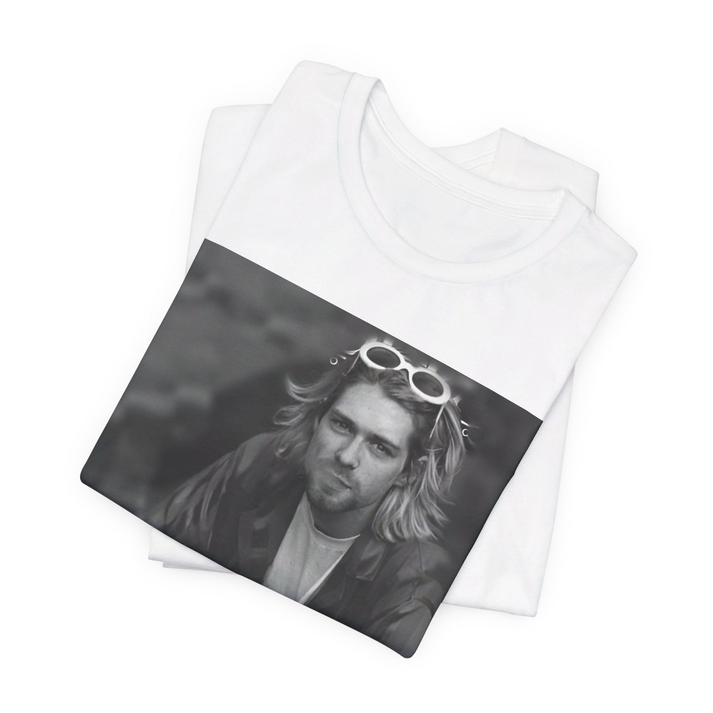 A black graphic t-shirt featuring a 90s black and white photo portrait of Kurt Cobain from Nirvana.