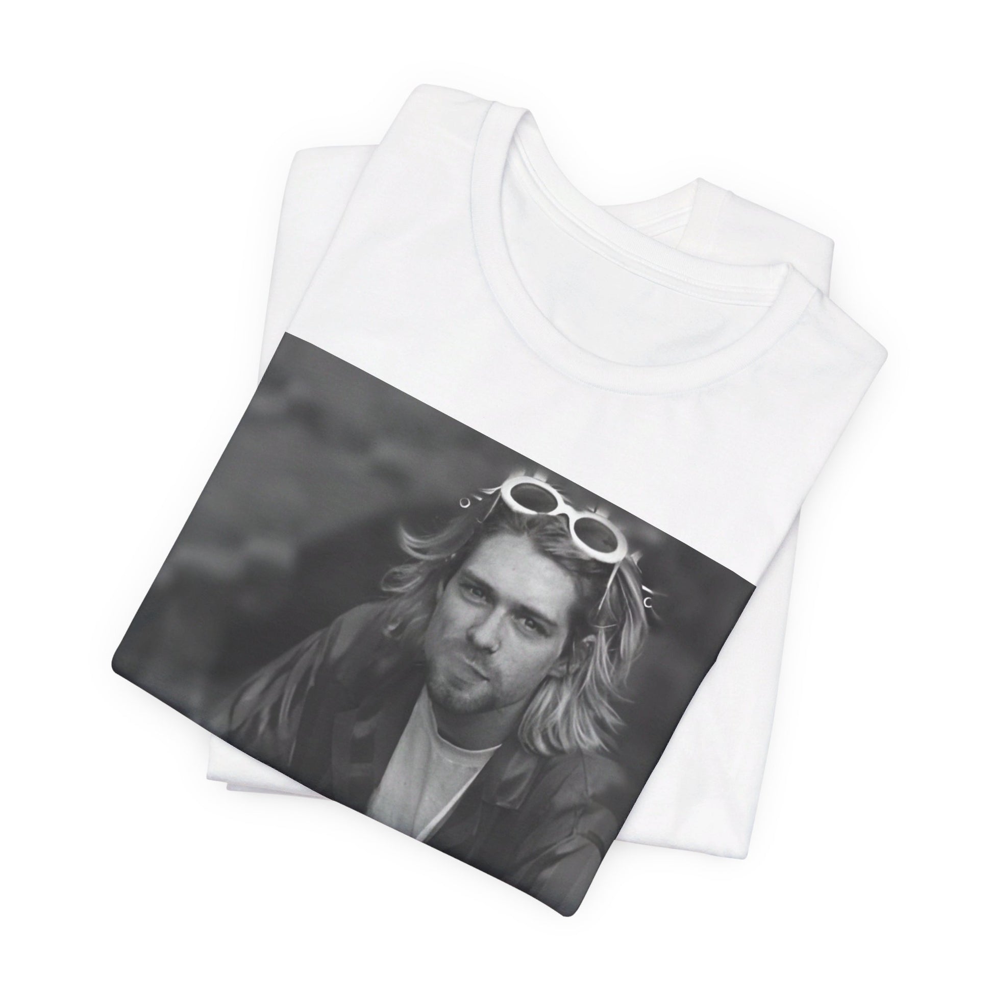 A black graphic t-shirt featuring a 90s black and white photo portrait of Kurt Cobain from Nirvana.