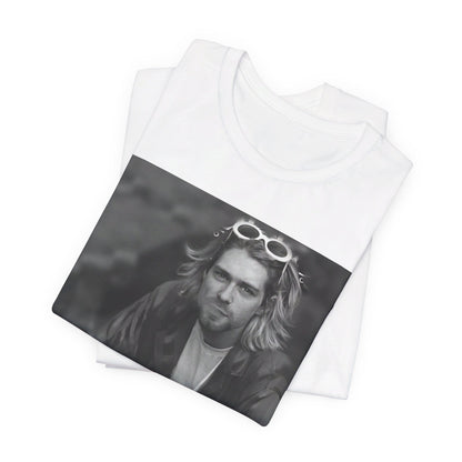 A black graphic t-shirt featuring a 90s black and white photo portrait of Kurt Cobain from Nirvana.