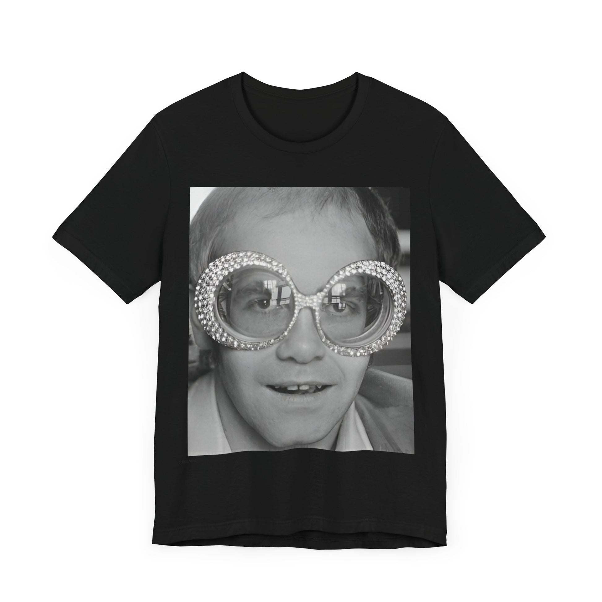 A black graphic t-shirt featuring a graphic of Elton John emphasizing his iconic glasses and fashion.