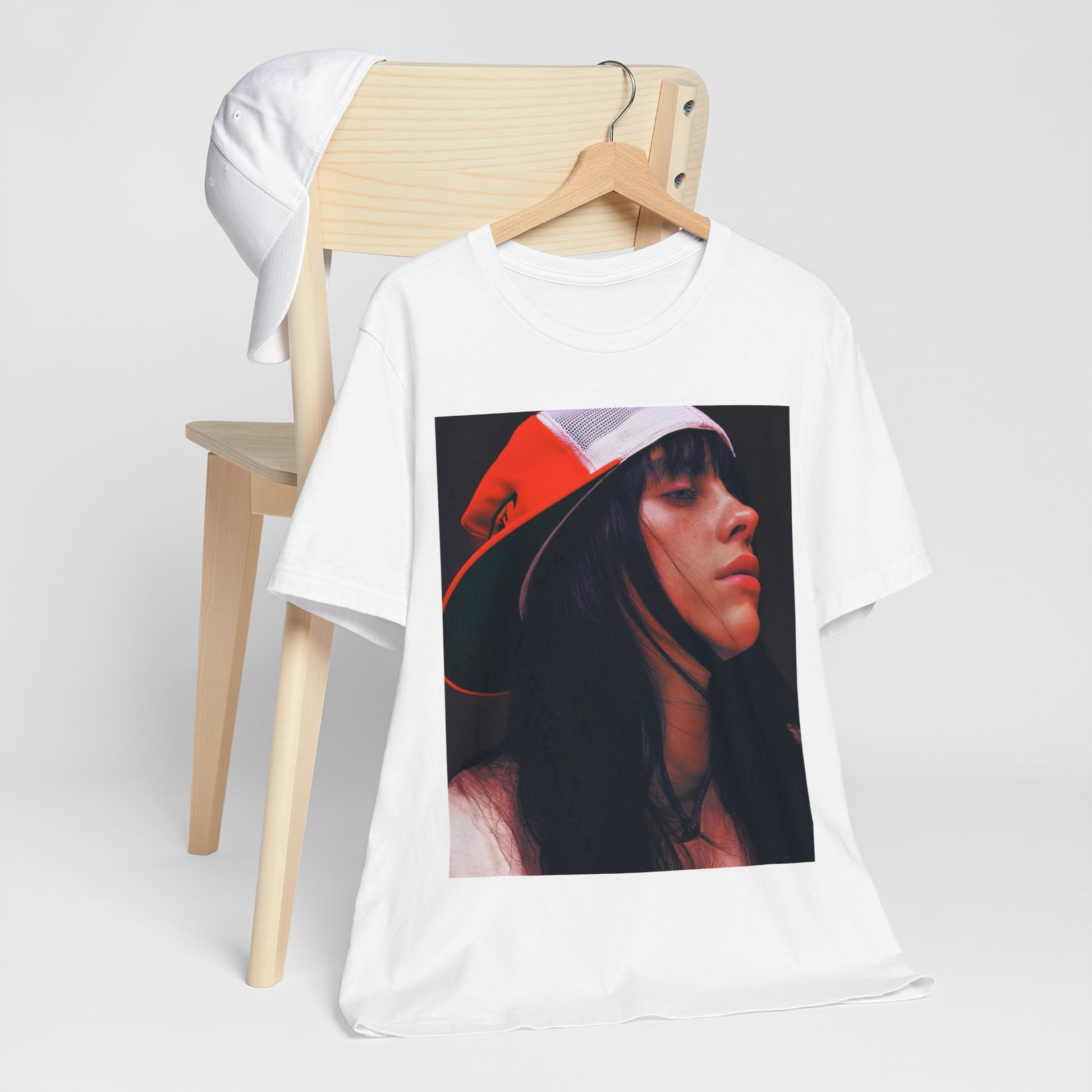 A graphic t-shirt featuring the name 'Billie Eilish' in a raw, urban street-style font.