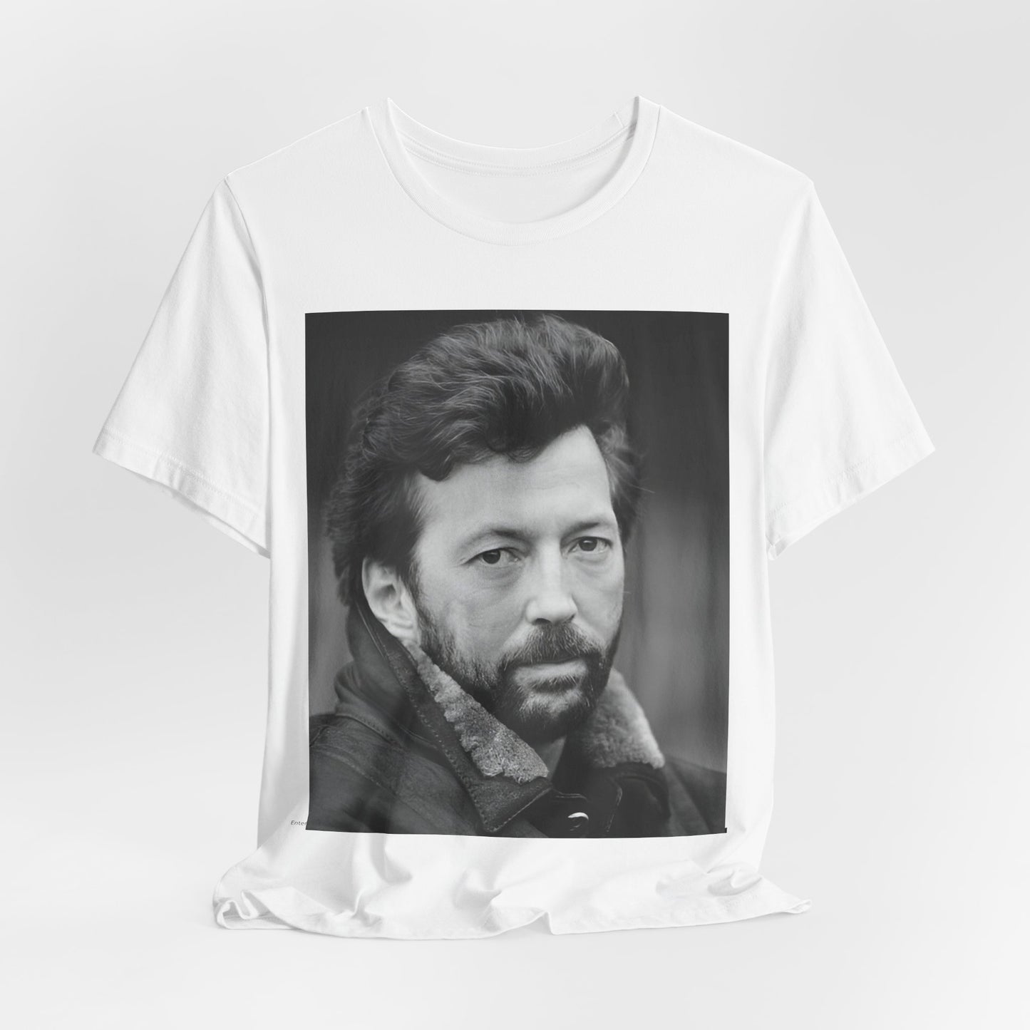 A black graphic t-shirt featuring a 70s rock aesthetic graphic of Eric Clapton.