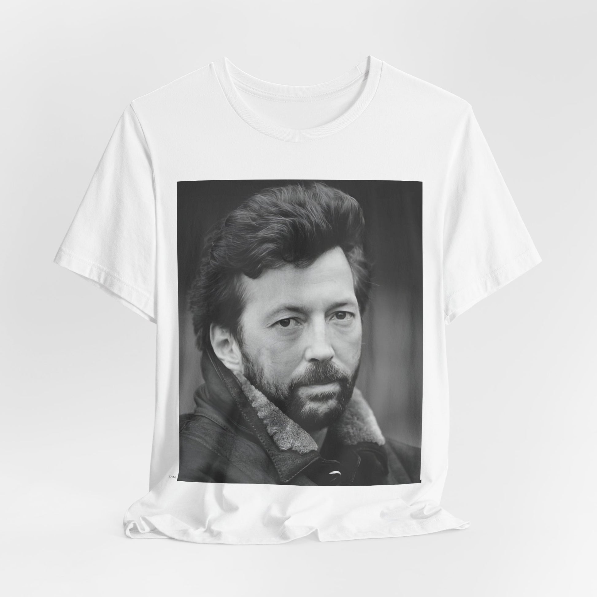 A black graphic t-shirt featuring a 70s rock aesthetic graphic of Eric Clapton.