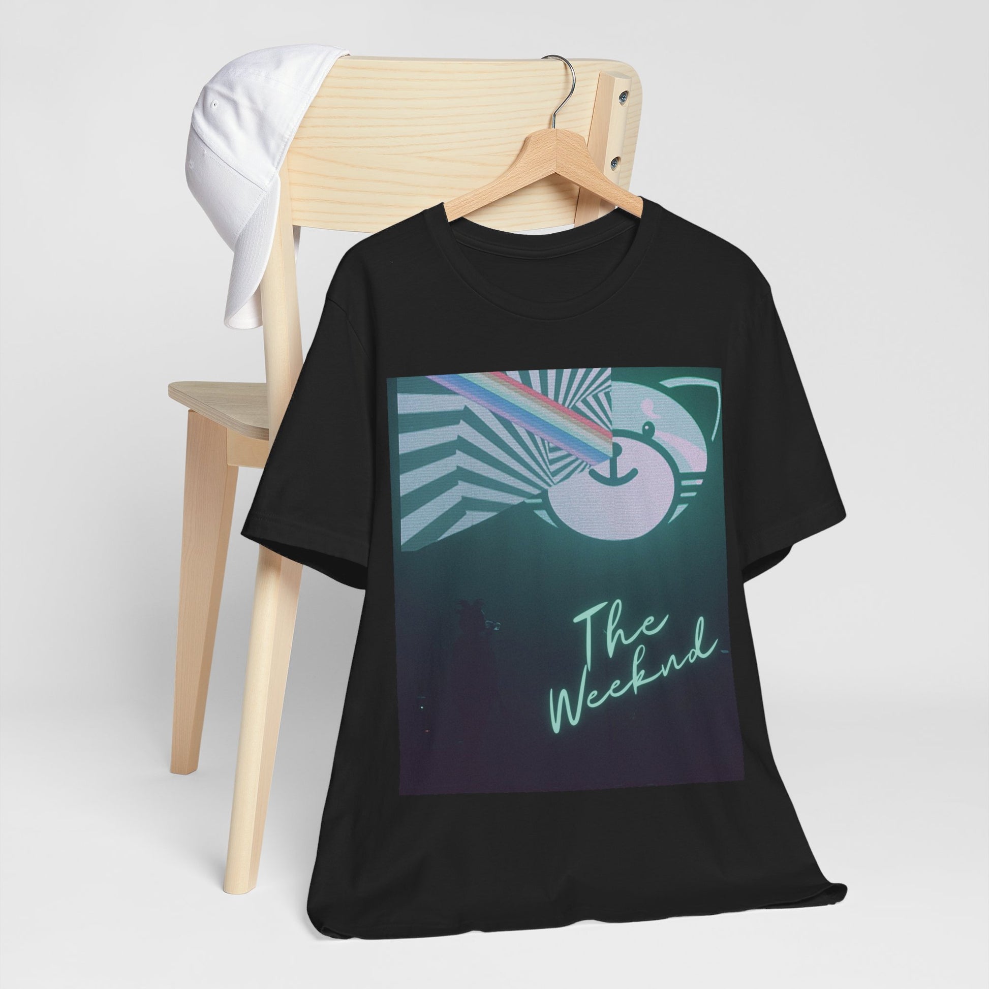 A black graphic t-shirt featuring a vintage concert graphic of The Weeknd from his 'Kiss Land' era.