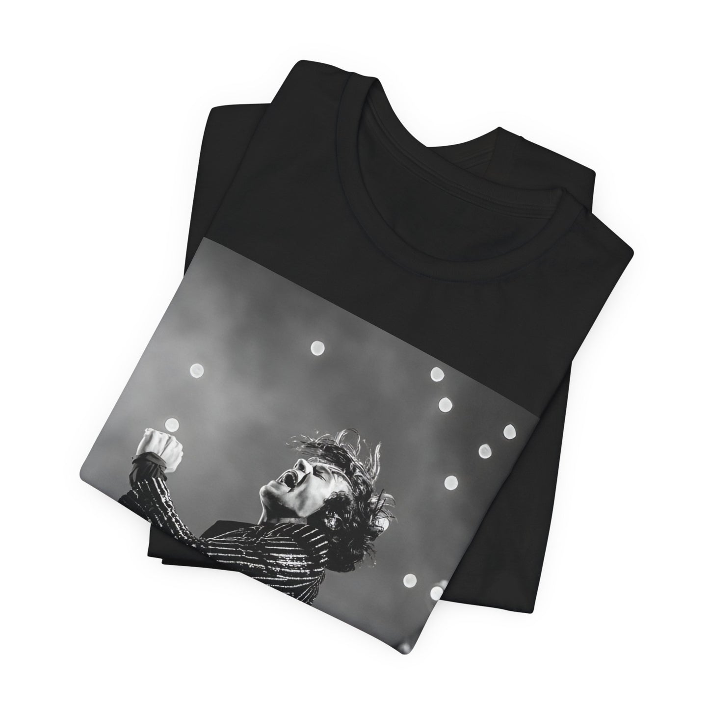 A black graphic t-shirt featuring a glamorous graphic or photo of Harry Styles performing on stage.