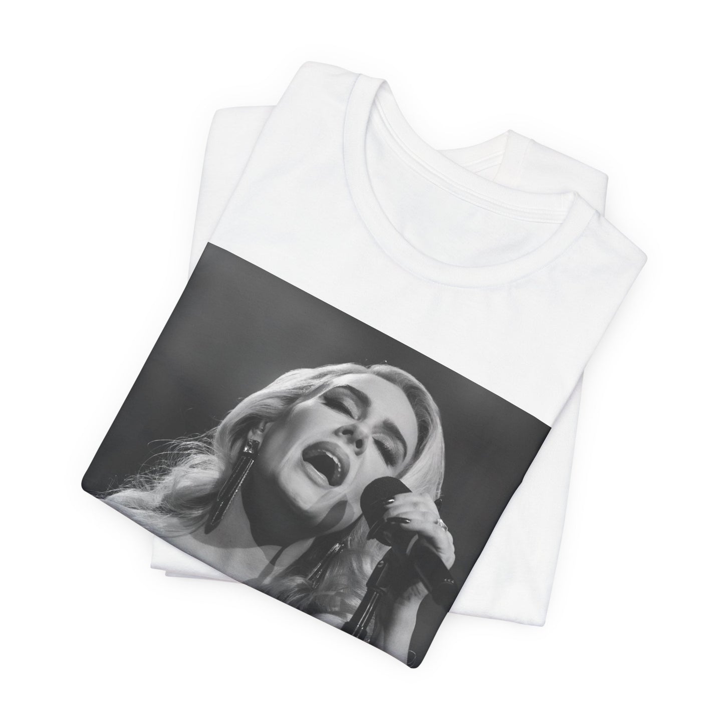 A black graphic t-shirt featuring a dynamic image of Adele performing on stage, with lighting effects, likely from her 'One Night Only' concert special.
