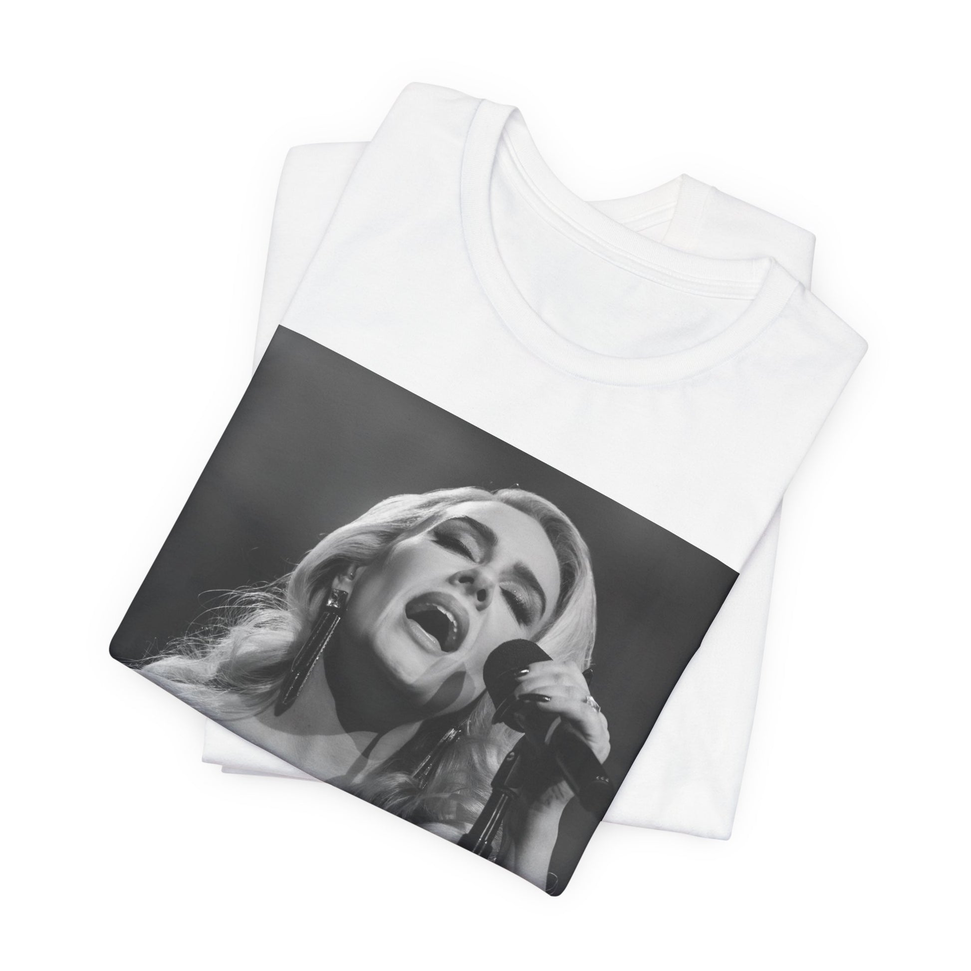 A black graphic t-shirt featuring a dynamic image of Adele performing on stage, with lighting effects, likely from her 'One Night Only' concert special.