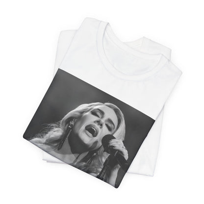 A black graphic t-shirt featuring a dynamic image of Adele performing on stage, with lighting effects, likely from her 'One Night Only' concert special.