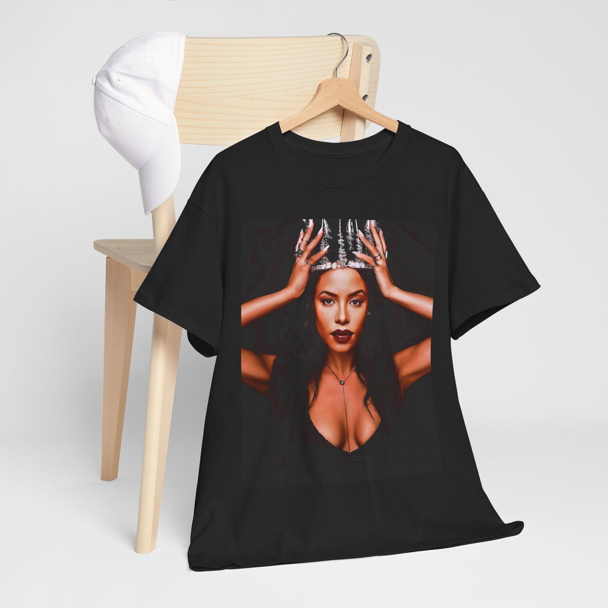 A black graphic t-shirt featuring a boxy graphic related to Aaliyah's 'More Than a Woman' song or era.