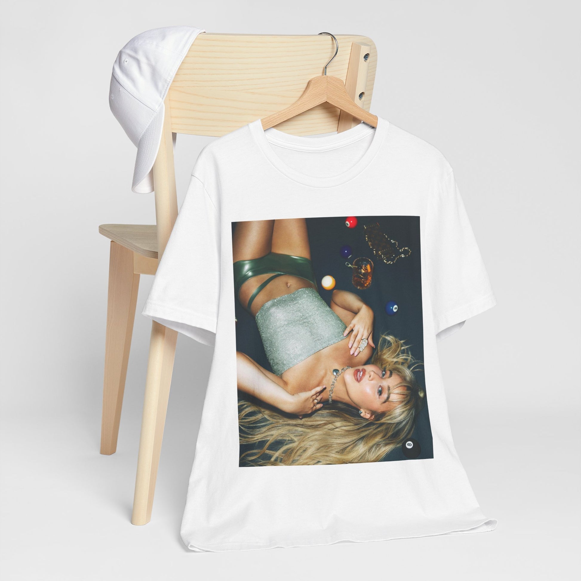 A black graphic t-shirt featuring a vintage pop icon graphic of Sabrina Carpenter.