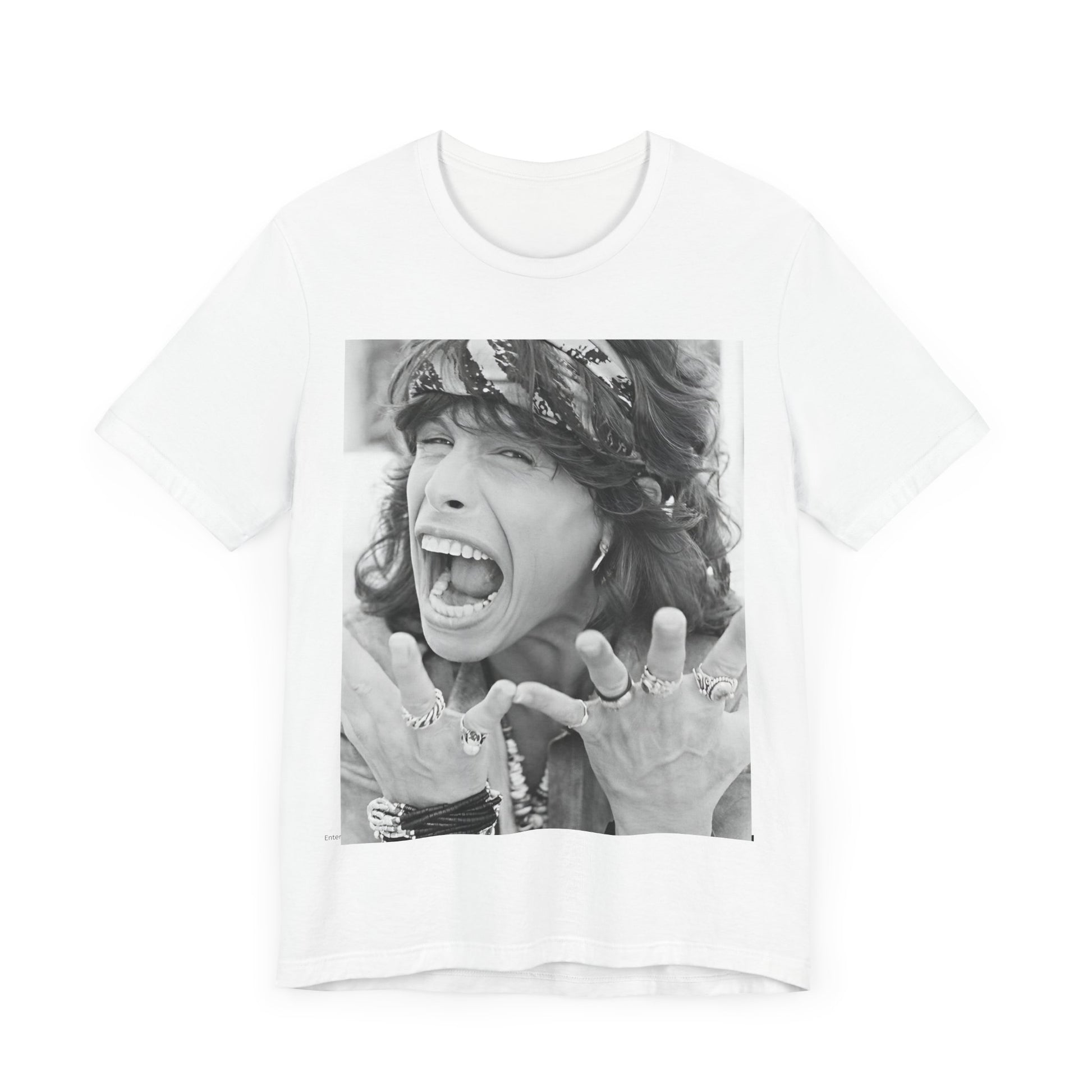 A black graphic t-shirt featuring a candid, dynamic photo of Aerosmith band members on tour in the 1970s, possibly showing action or interaction on stage or backstage.