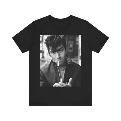 A black graphic t-shirt featuring a graphic of Alex Turner from Arctic Monkeys, in a rock star pose or setting.