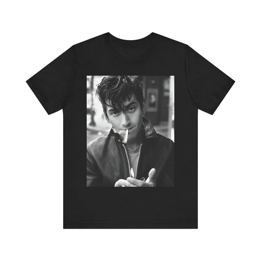 A black graphic t-shirt featuring a graphic of Alex Turner from Arctic Monkeys, in a rock star pose or setting.