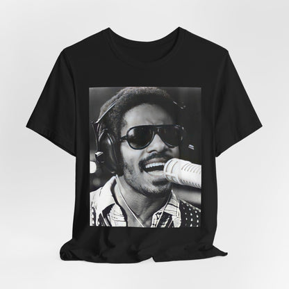 A black graphic t-shirt featuring a graphic of Stevie Wonder as a timeless visionary.
