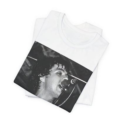 A black graphic t-shirt featuring a black and white graphic or photo of Green Day performing live on stage.