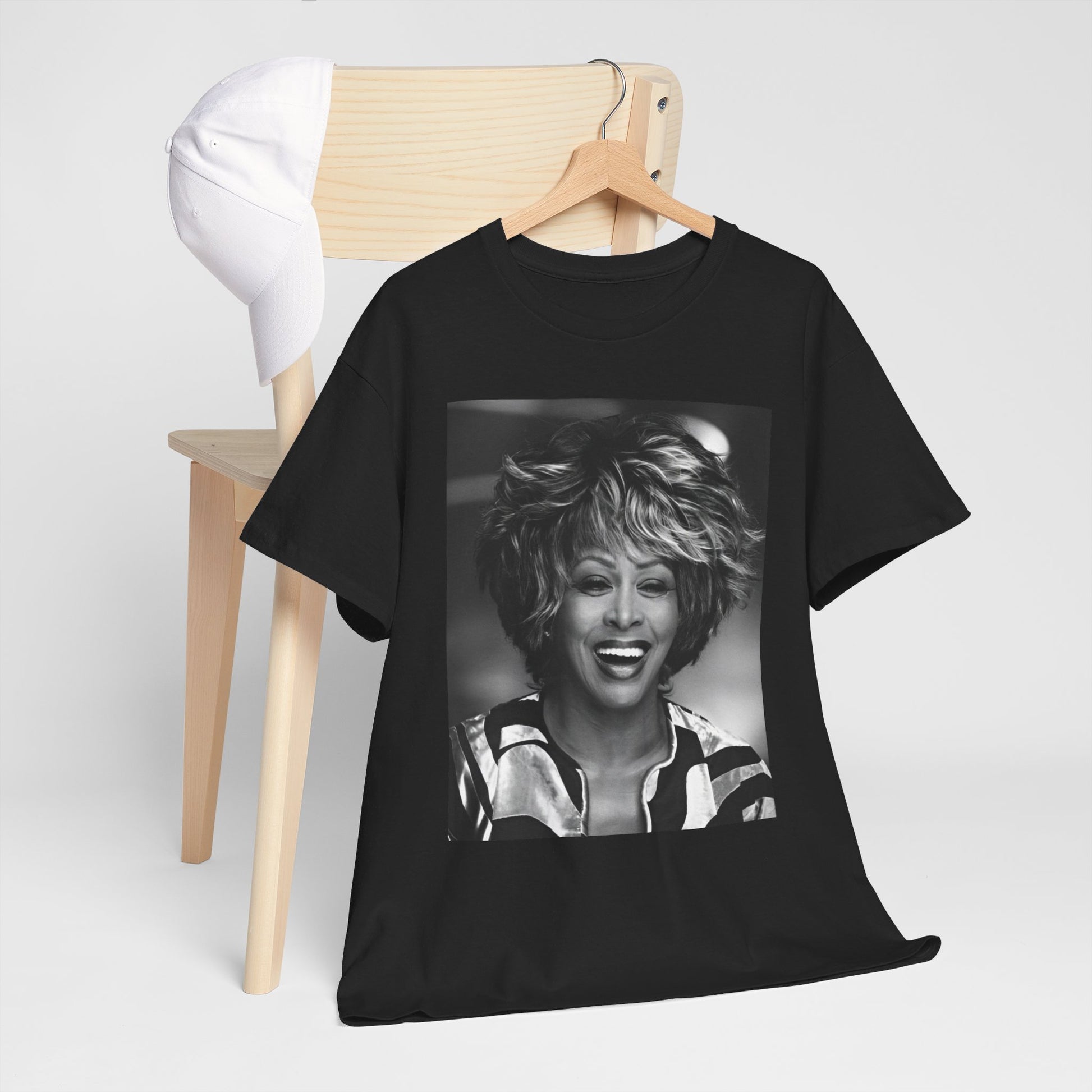 A black graphic t-shirt featuring a classic 80s pop aesthetic graphic of Tina Turner.