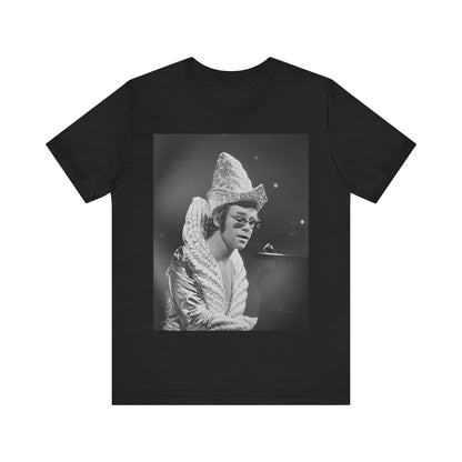 A black graphic t-shirt featuring a 70s pop aesthetic graphic of Elton John.