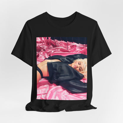 A black graphic t-shirt featuring a vintage aesthetic graphic related to Karol G's 'Tusa' era.