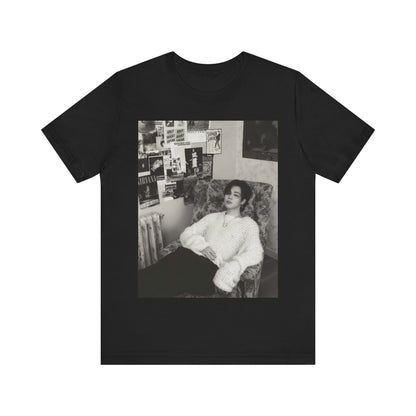 A black graphic t-shirt featuring a black and white portrait photo of Jimin.