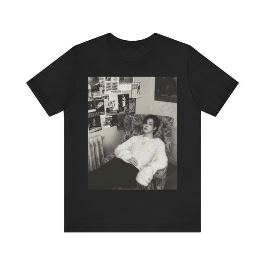 A black graphic t-shirt featuring a black and white portrait photo of Jimin.
