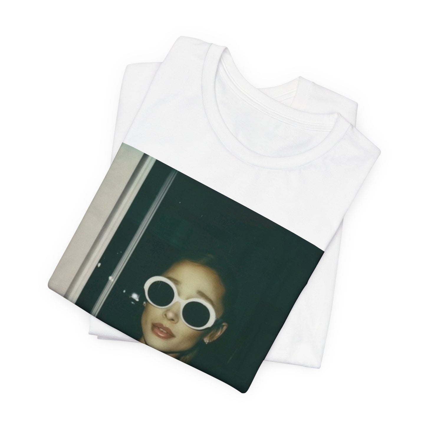 A black graphic t-shirt featuring a retro Polaroid-style photo of Ariana Grande.