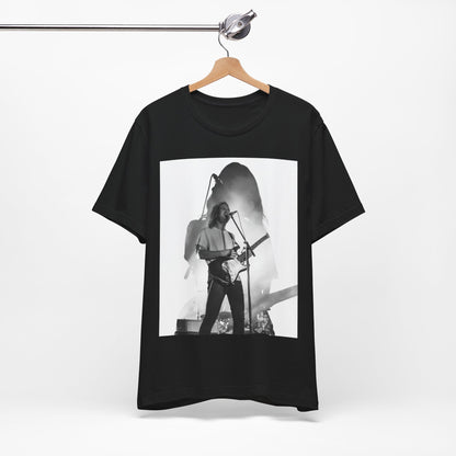 A black graphic t-shirt featuring a black and white, monochrome graphic or photo of Tame Impala.