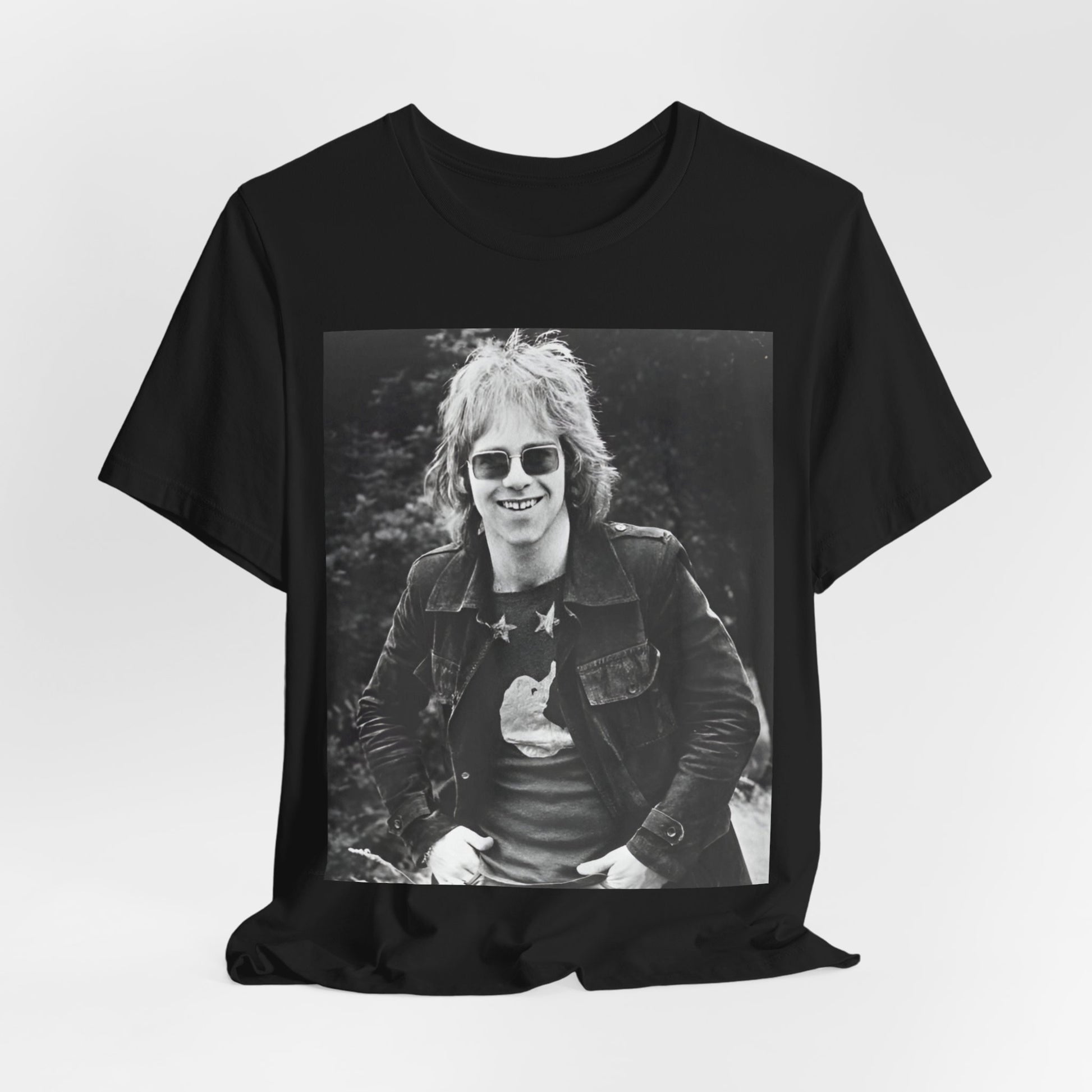 A black graphic t-shirt featuring a 70s black and white monochrome graphic or photo of Elton John.