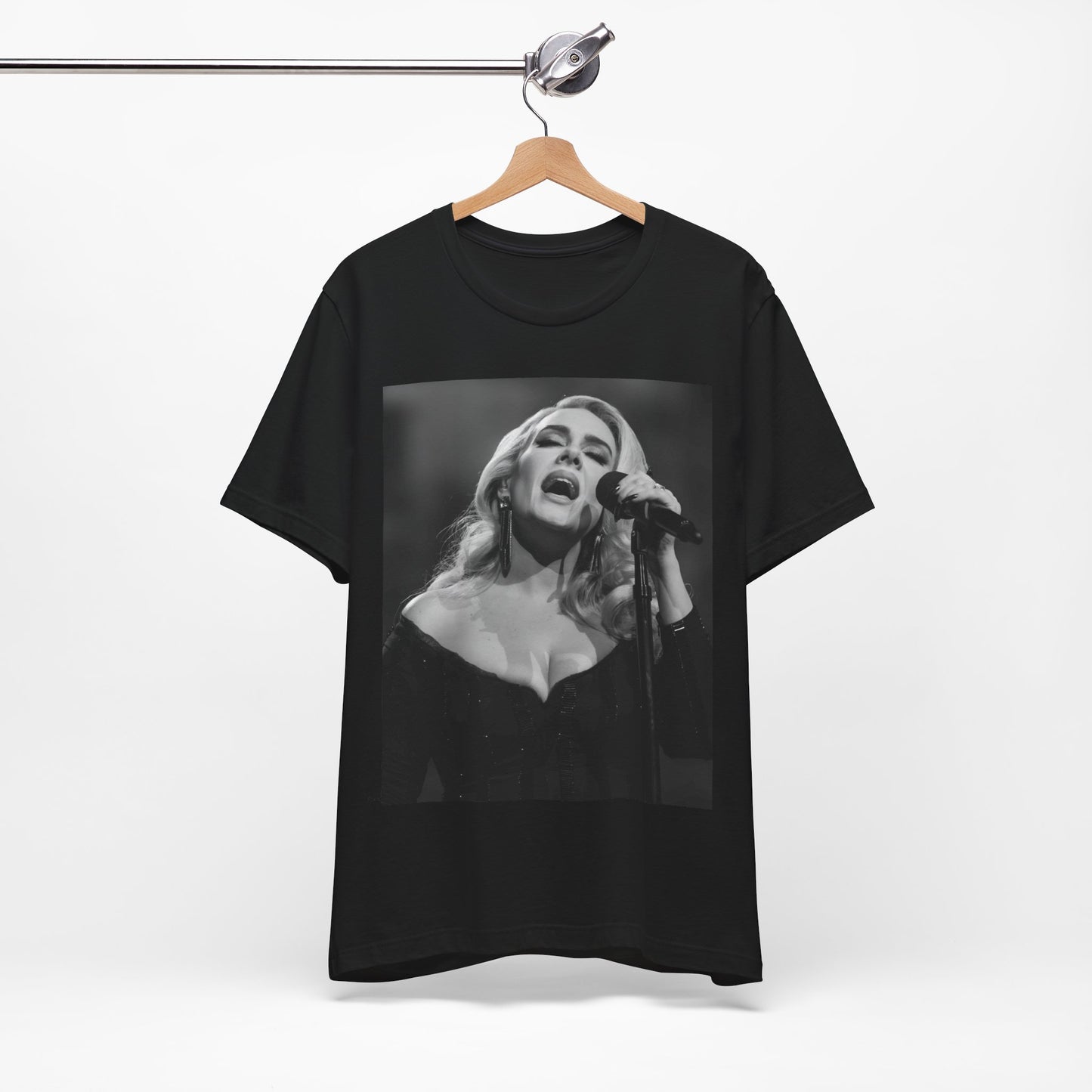 A black graphic t-shirt featuring a dynamic image of Adele performing on stage, with lighting effects, likely from her 'One Night Only' concert special.