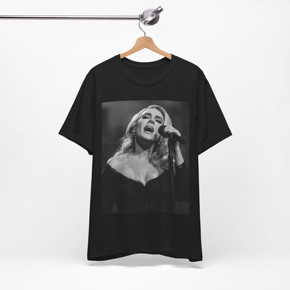 A black graphic t-shirt featuring a dynamic image of Adele performing on stage, with lighting effects, likely from her 'One Night Only' concert special.
