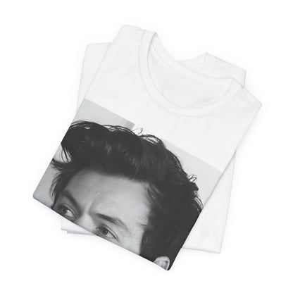 A black graphic t-shirt featuring a black and white, monochrome graphic or photo of Harry Styles.