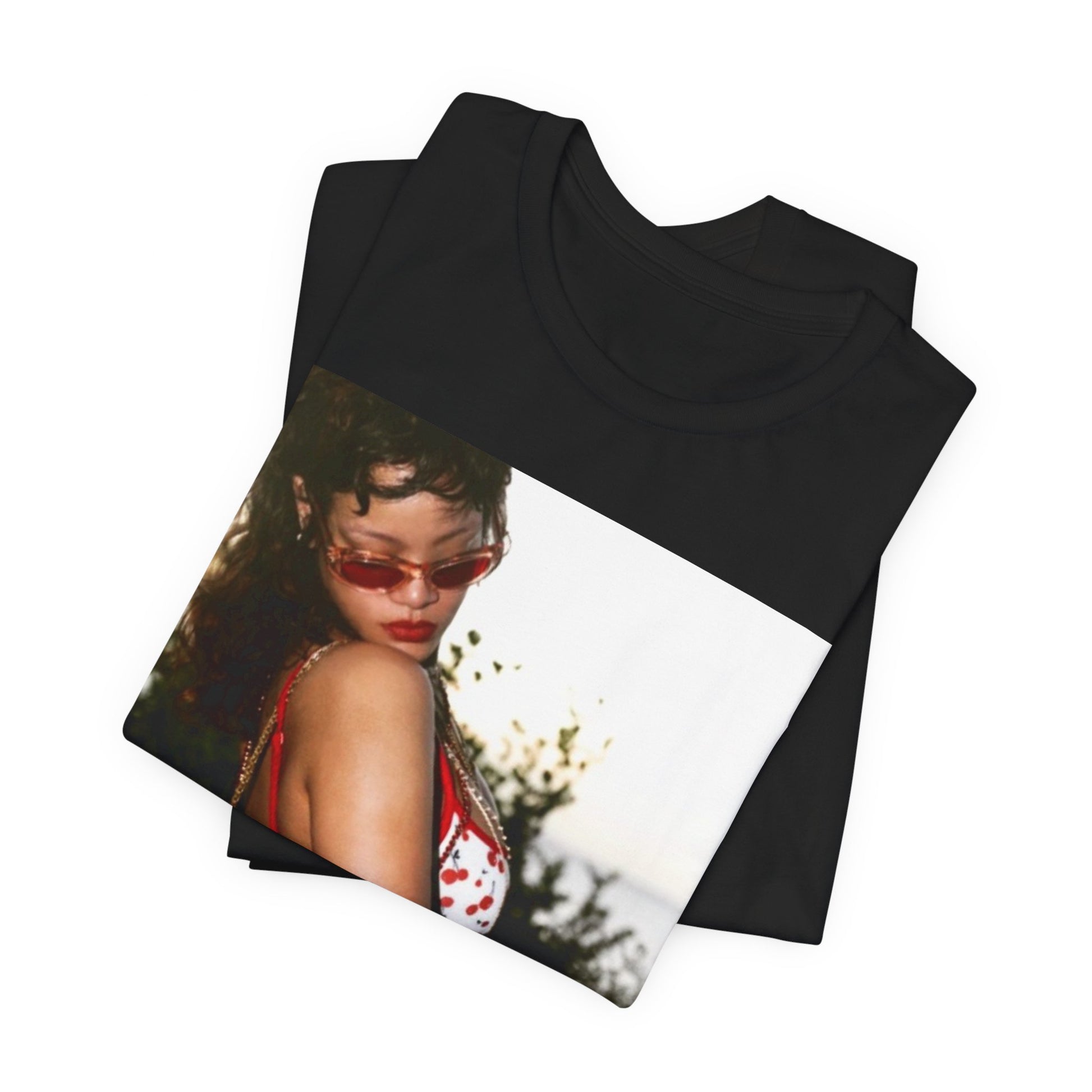 A black graphic t-shirt featuring a photo graphic of Rihanna in a bikini.