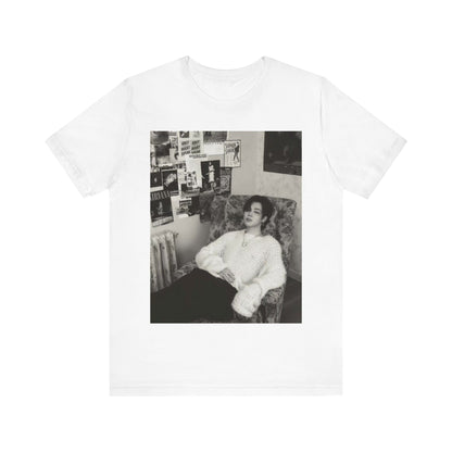 A black graphic t-shirt featuring a black and white portrait photo of Jimin.