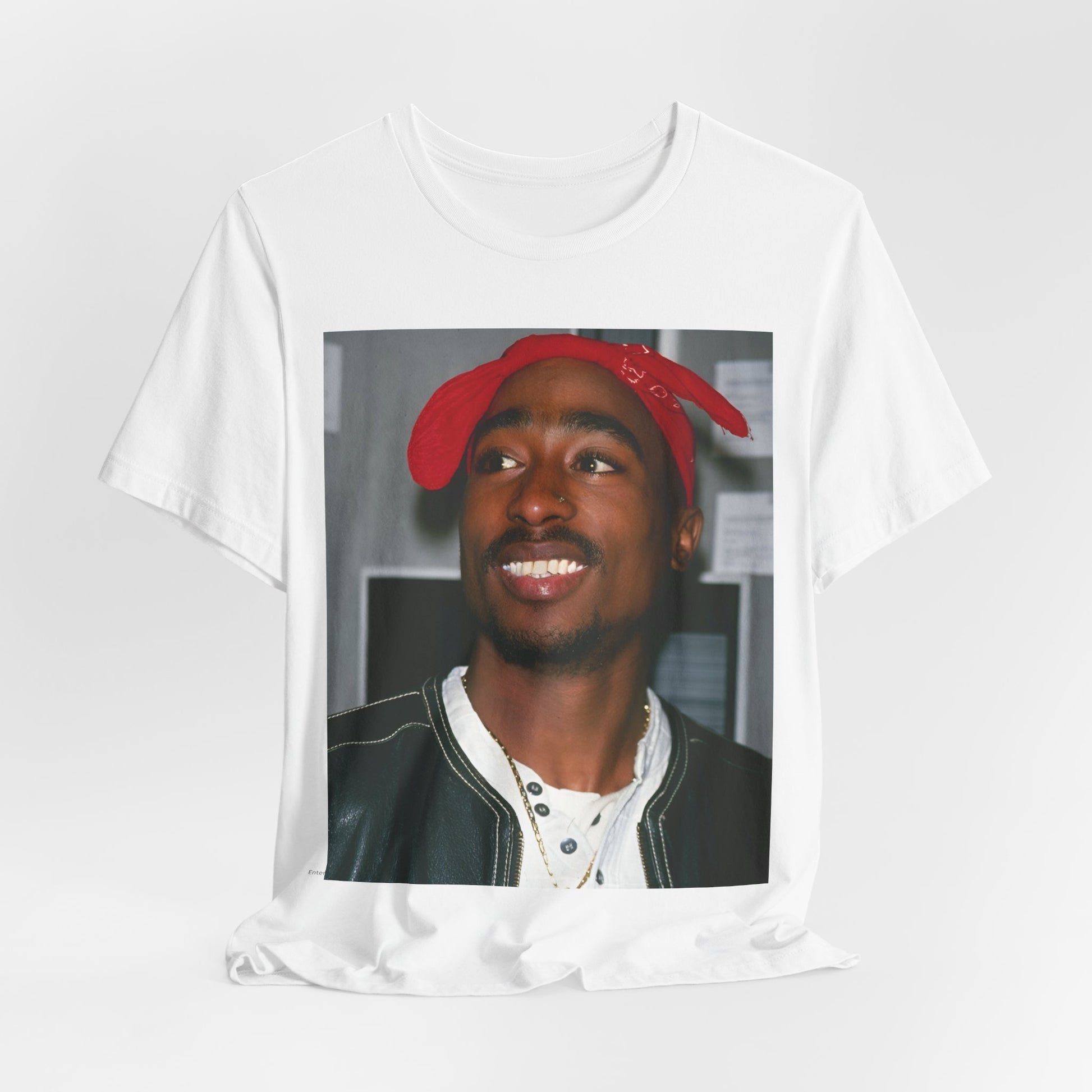 A black graphic t-shirt featuring a graphic of Tupac with his iconic bandana style.