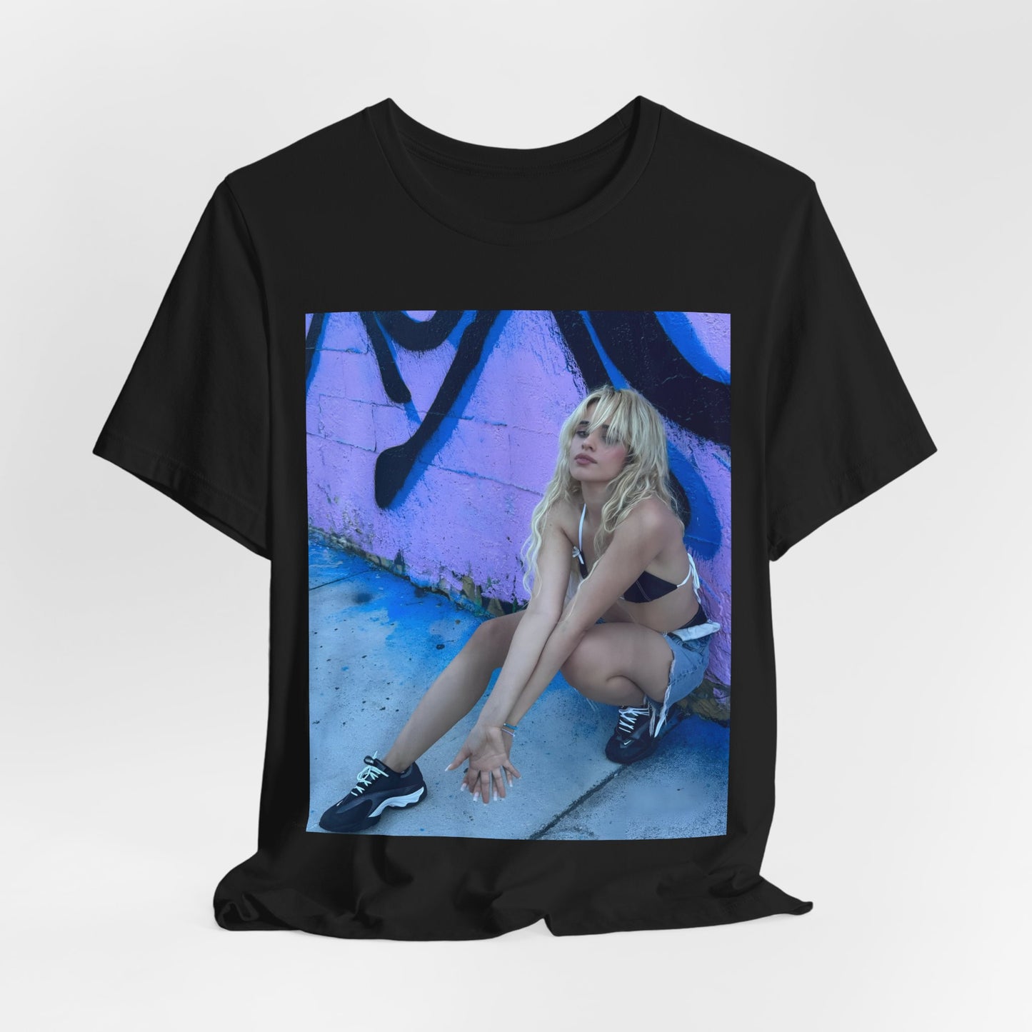 A black graphic t-shirt featuring a photo of Camila Cabello from her "Romance" album era.