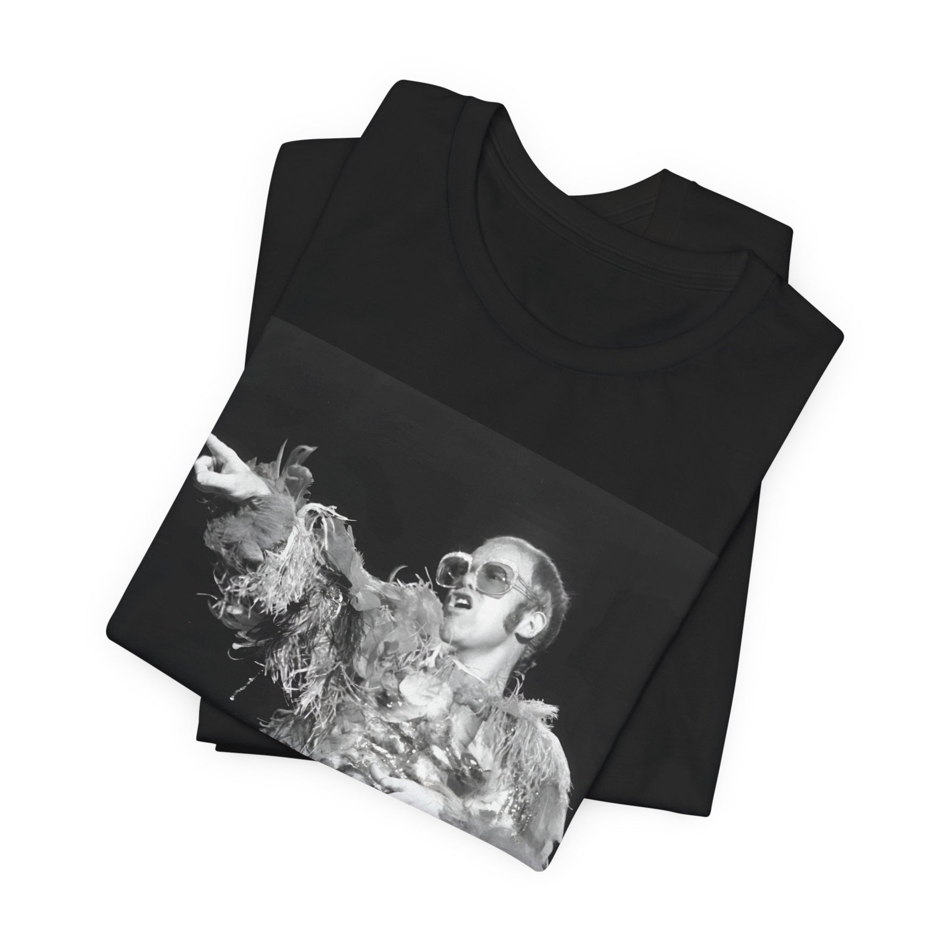 A black graphic t-shirt featuring a retro graphic of Elton John as a rock legend performing live.