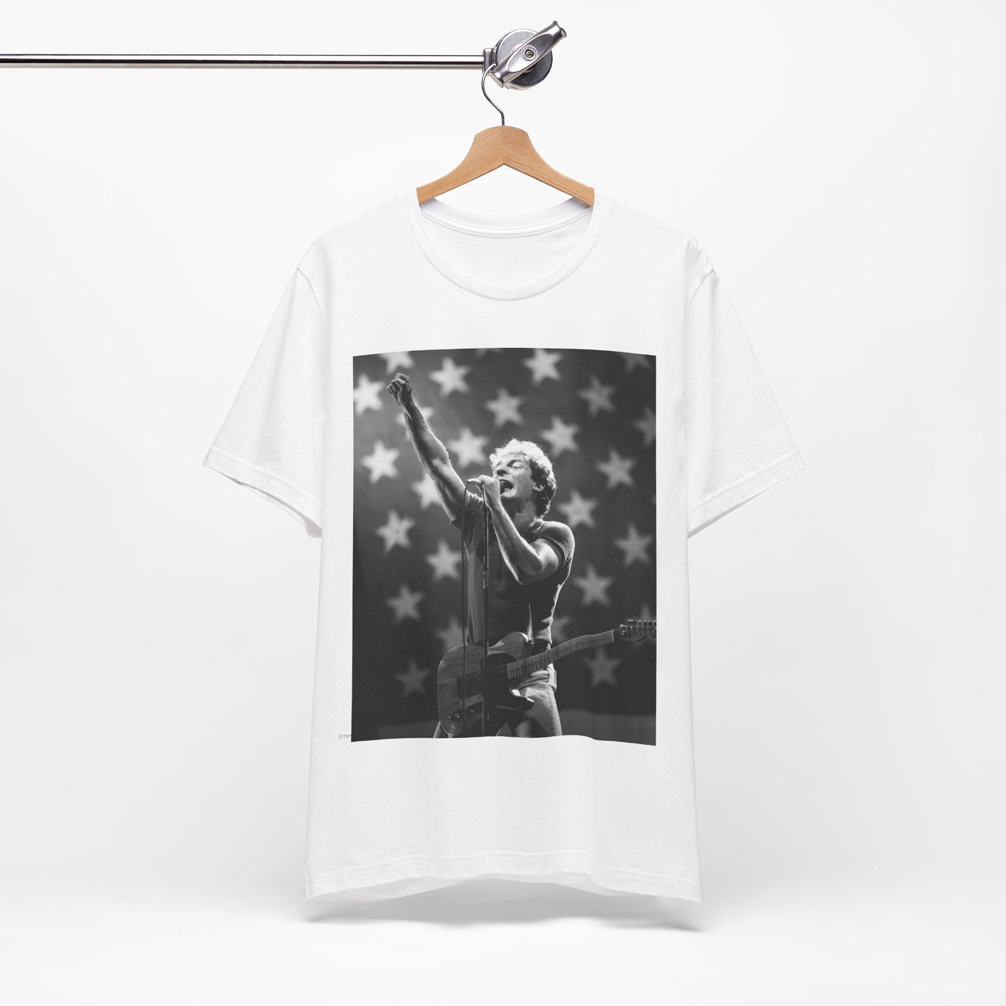 A black graphic t-shirt featuring a 70s era Americana-style graphic of Bruce Springsteen.
